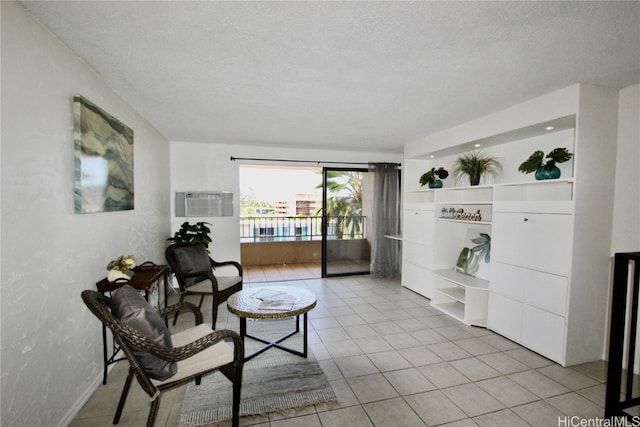 living area featuring light tile patterned flooring and a textured ceiling