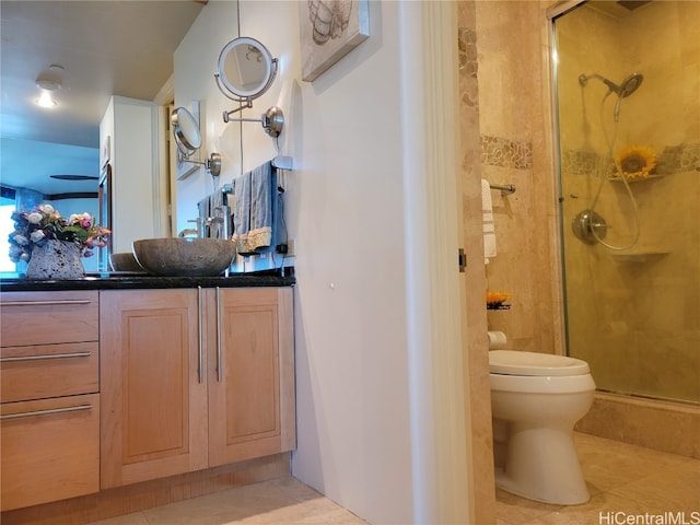 bathroom featuring vanity, toilet, tile patterned floors, and walk in shower