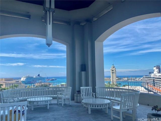 view of patio / terrace with a balcony and a water view