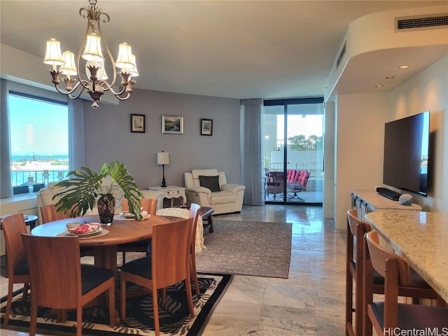 dining room featuring an inviting chandelier and plenty of natural light