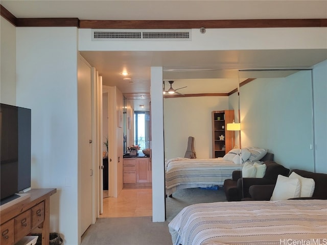 carpeted bedroom with crown molding and ceiling fan