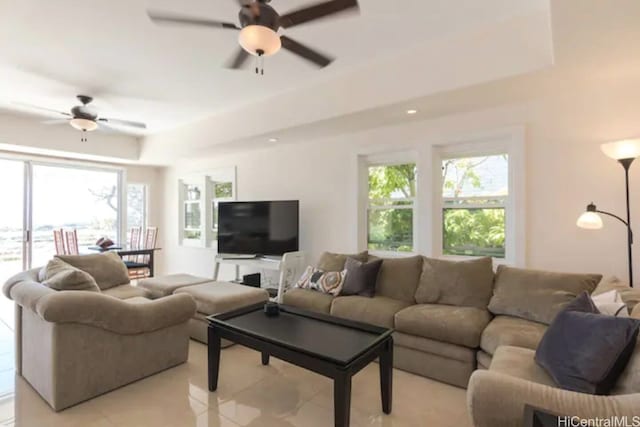 living room with ceiling fan and plenty of natural light