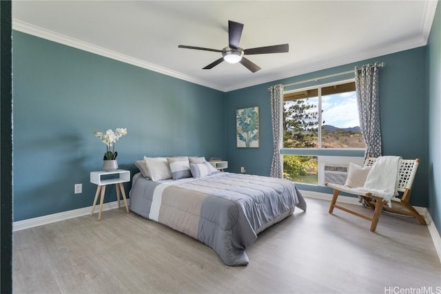 bedroom featuring ceiling fan, ornamental molding, a wall mounted AC, and light wood-type flooring