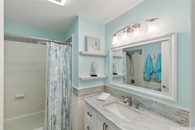 full bathroom with decorative backsplash, vanity, toilet, and shower / bath combo with shower curtain