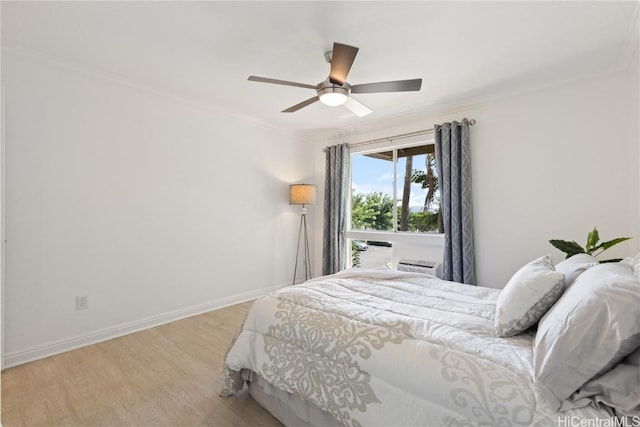 bedroom with ceiling fan, ornamental molding, and light wood-type flooring