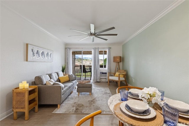 living room with hardwood / wood-style floors, ornamental molding, and ceiling fan