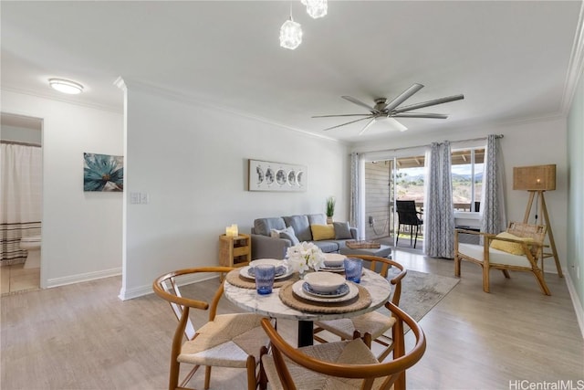 dining room with ornamental molding, ceiling fan, and light wood-type flooring