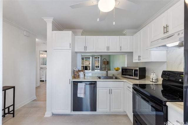 kitchen with sink, white cabinets, ornamental molding, ceiling fan, and stainless steel appliances