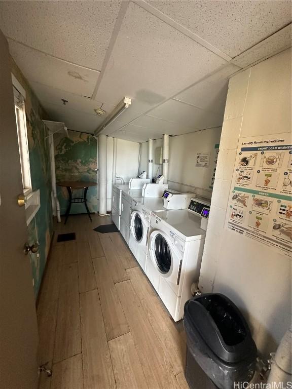 clothes washing area with light hardwood / wood-style floors and independent washer and dryer