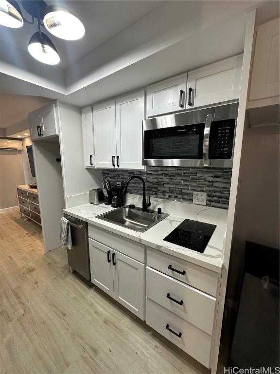 kitchen featuring sink, white cabinets, and stainless steel appliances