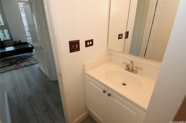 2421 Tusitala St Unit 1402, Honolulu, HI 96815 - bathroom featuring baseboards, wood finished floors, and vanity