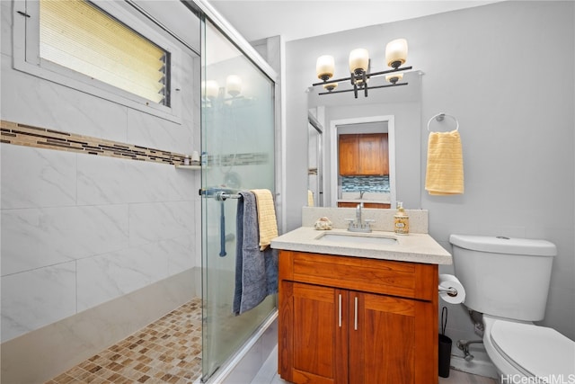 bathroom with walk in shower, vanity, and toilet