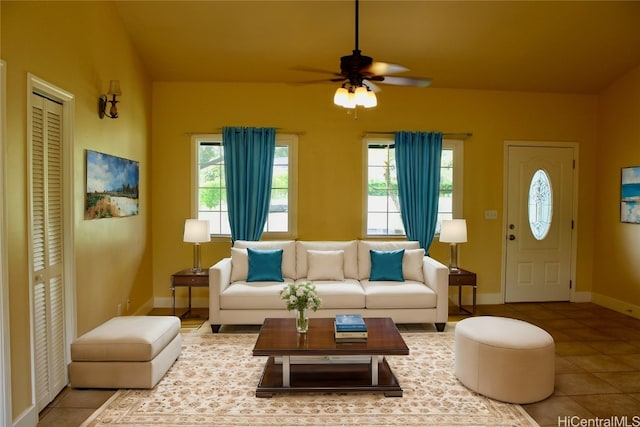 tiled living room with plenty of natural light and ceiling fan