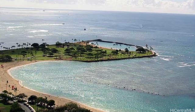 drone / aerial view featuring a beach view and a water view