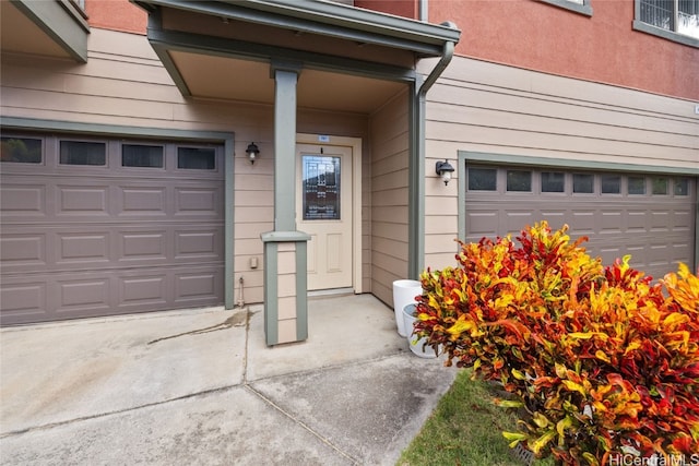 doorway to property with a garage