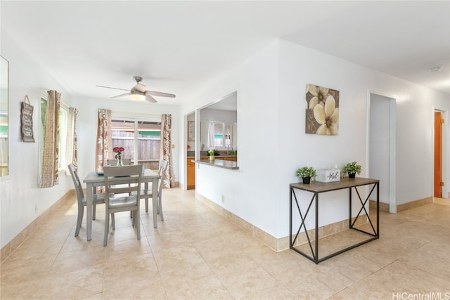 dining space featuring ceiling fan and light tile patterned floors