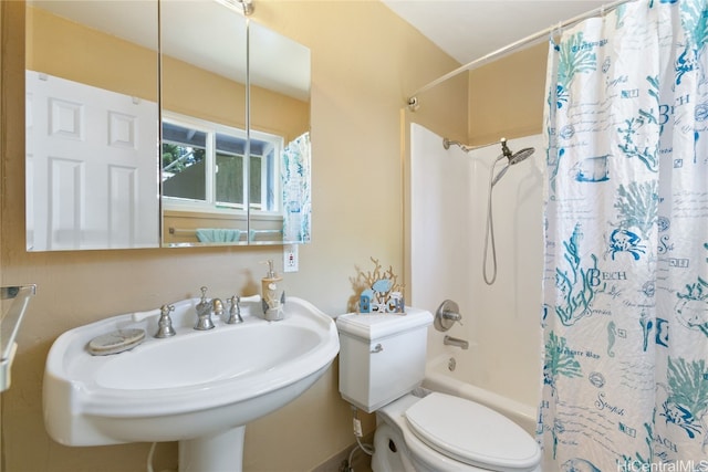 full bathroom with sink, shower / bath combo with shower curtain, and toilet