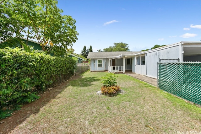 rear view of property featuring a lawn