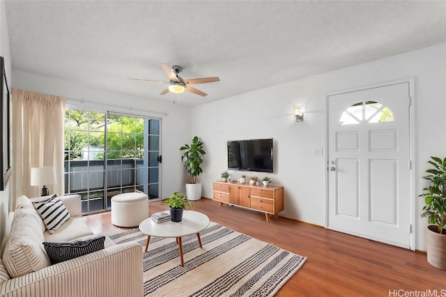 living room with ceiling fan, a wealth of natural light, and hardwood / wood-style floors