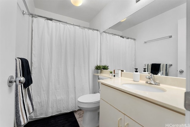 bathroom with vanity, curtained shower, and toilet