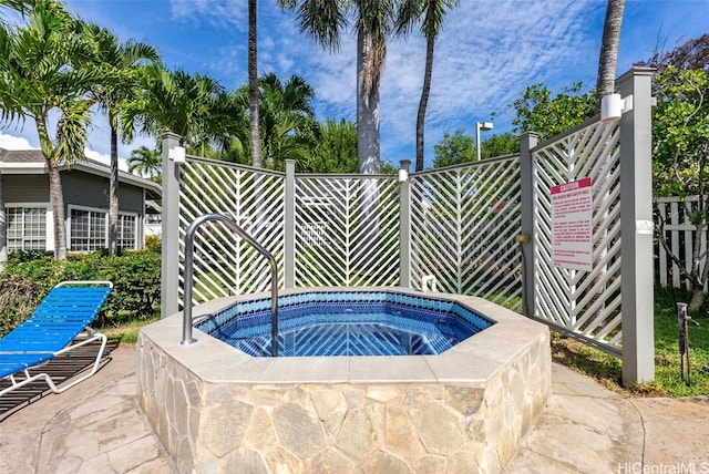 view of pool with a hot tub