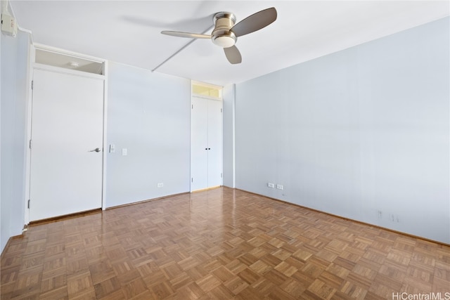 empty room with light parquet flooring and ceiling fan