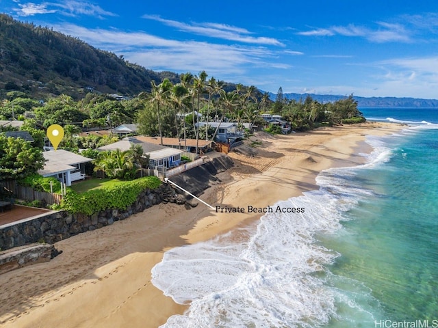 drone / aerial view featuring a water view and a beach view