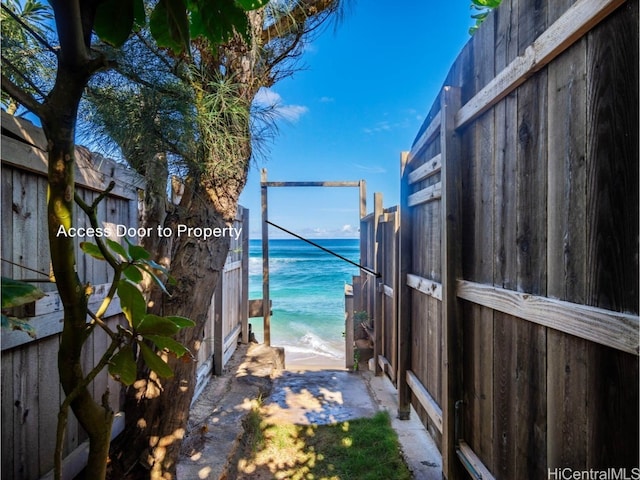 exterior space featuring a water view and a view of the beach