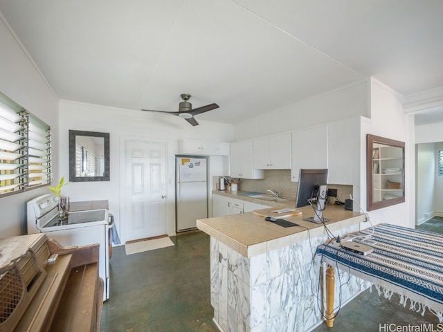 kitchen featuring backsplash, ornamental molding, white cabinets, white appliances, and ceiling fan