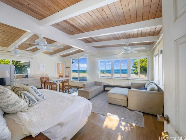 bedroom featuring beamed ceiling, wood ceiling, hardwood / wood-style flooring, and ceiling fan