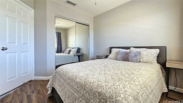 bedroom featuring a closet and dark hardwood / wood-style flooring