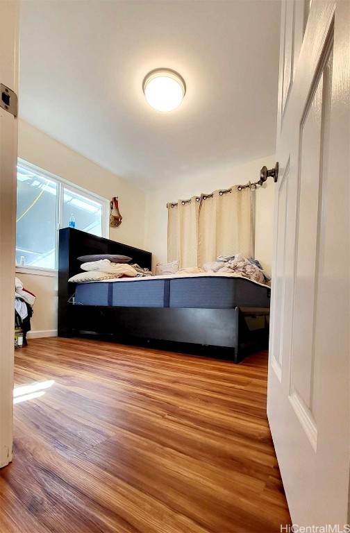 bedroom with hardwood / wood-style floors