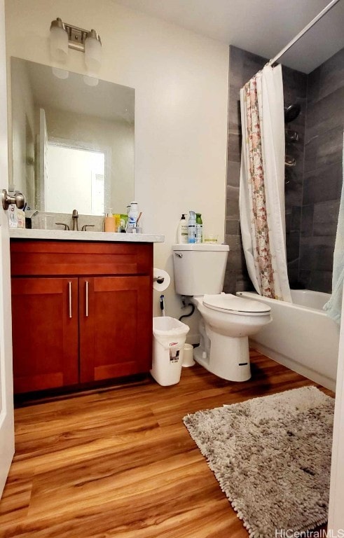 full bathroom with vanity, wood-type flooring, shower / tub combo with curtain, and toilet