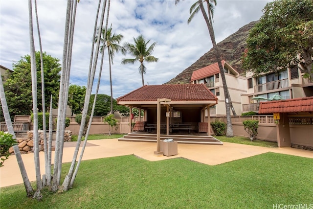 view of home's community featuring a patio and a lawn