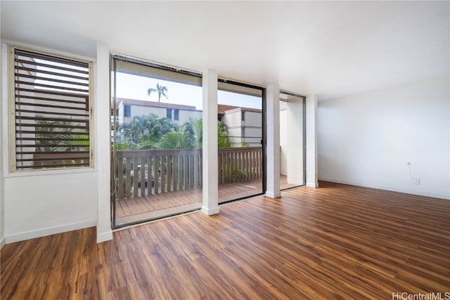 unfurnished room with dark hardwood / wood-style flooring