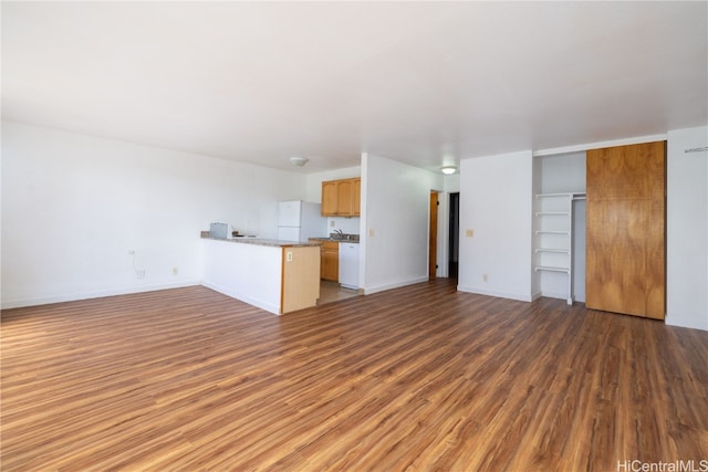 unfurnished living room with dark hardwood / wood-style flooring