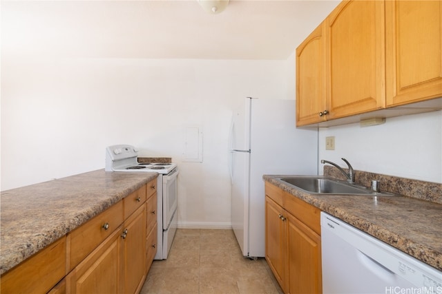 kitchen with white appliances, sink, and light tile patterned floors