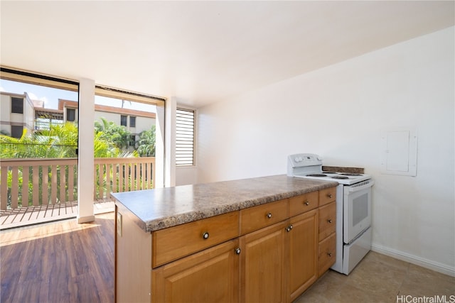 kitchen featuring white electric range oven, light wood-type flooring, and electric panel