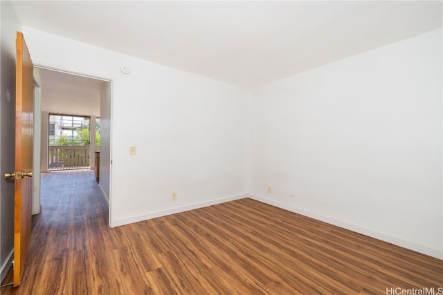 spare room with dark hardwood / wood-style flooring