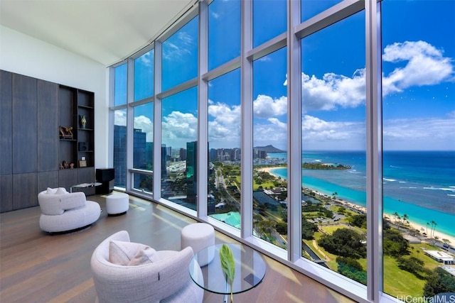 sunroom / solarium with a view of the beach and a water view