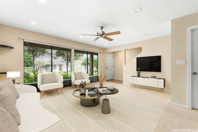 living room with ceiling fan and light colored carpet