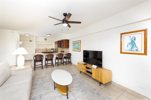 living room with a ceiling fan and light tile patterned floors