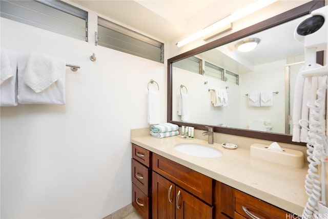 bathroom with vanity and a shower with shower door