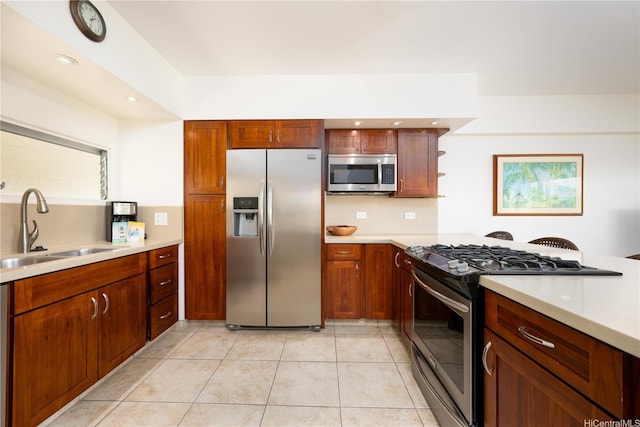 kitchen featuring open shelves, a sink, light countertops, light tile patterned floors, and stainless steel appliances