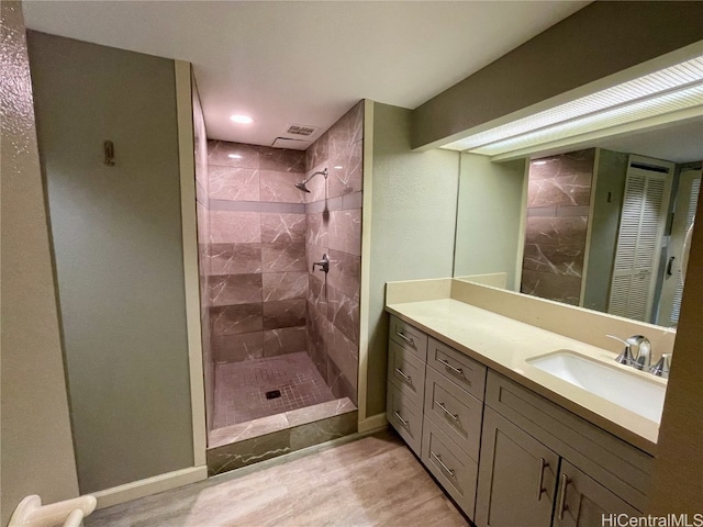 bathroom featuring vanity and a tile shower