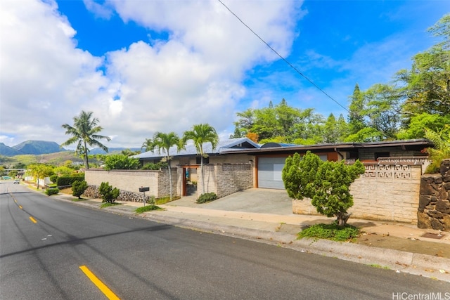 view of front of house featuring a mountain view and a garage