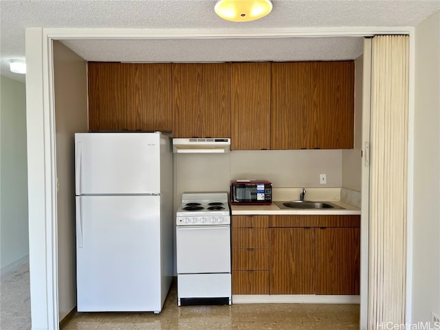 kitchen featuring sink, a textured ceiling, and white appliances