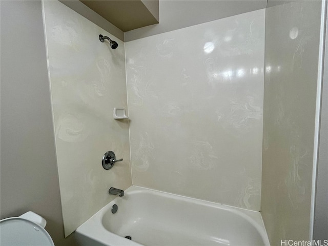 bathroom featuring washtub / shower combination and toilet