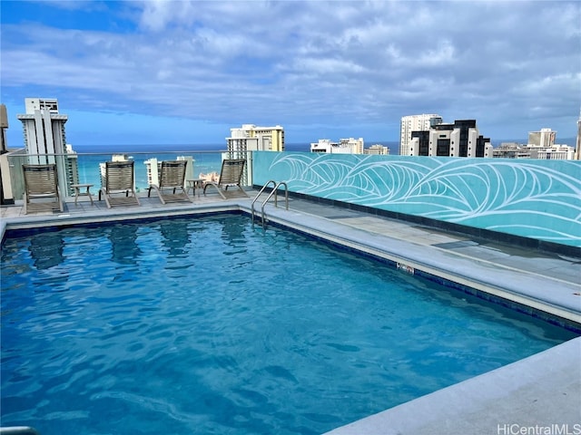 view of swimming pool with a water view