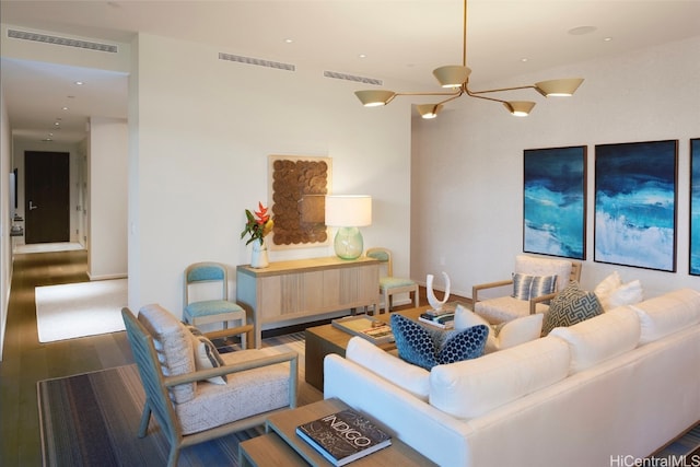 living room featuring hardwood / wood-style floors and an inviting chandelier